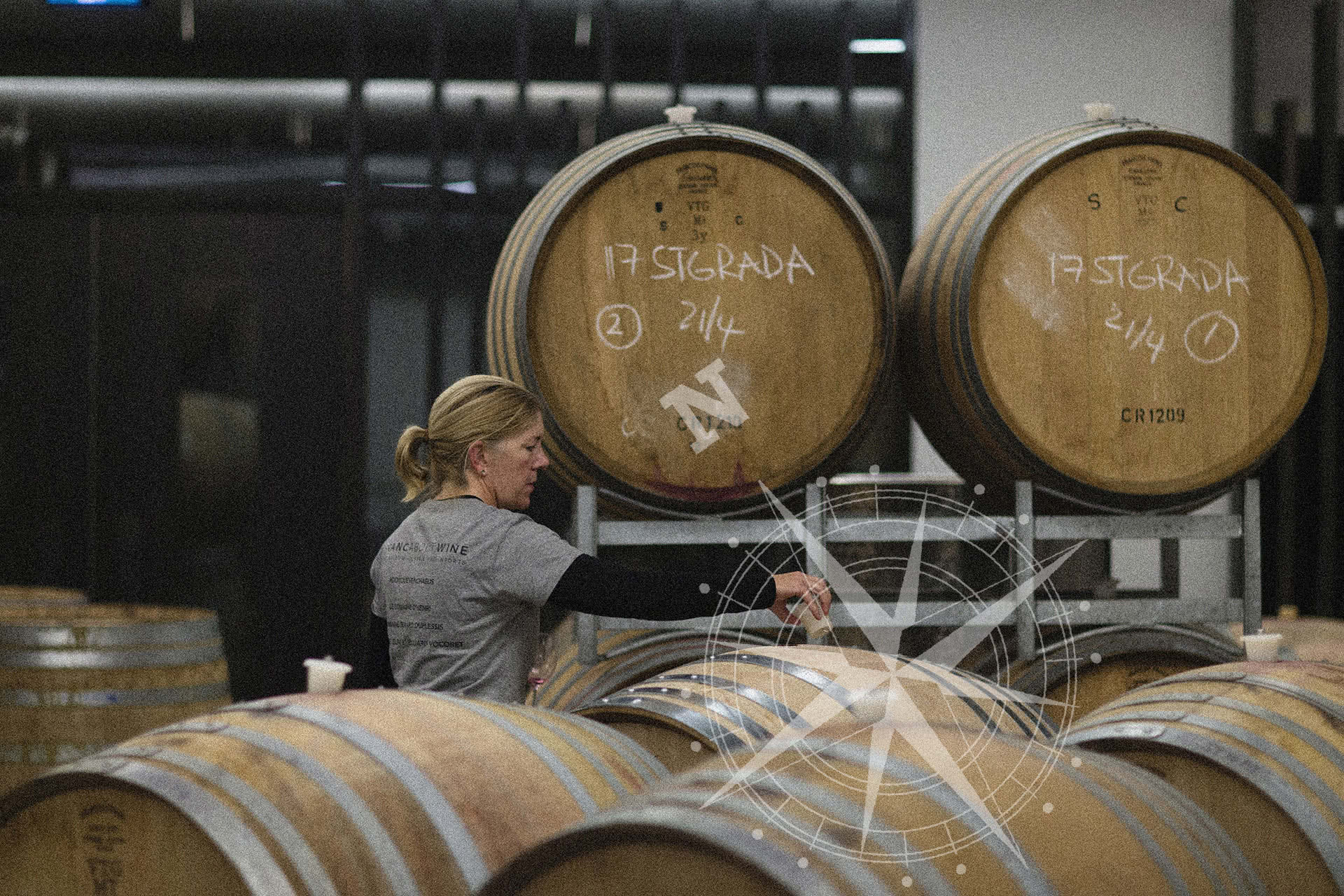 Winemaker Samantha Connew standing amongst wine barrels